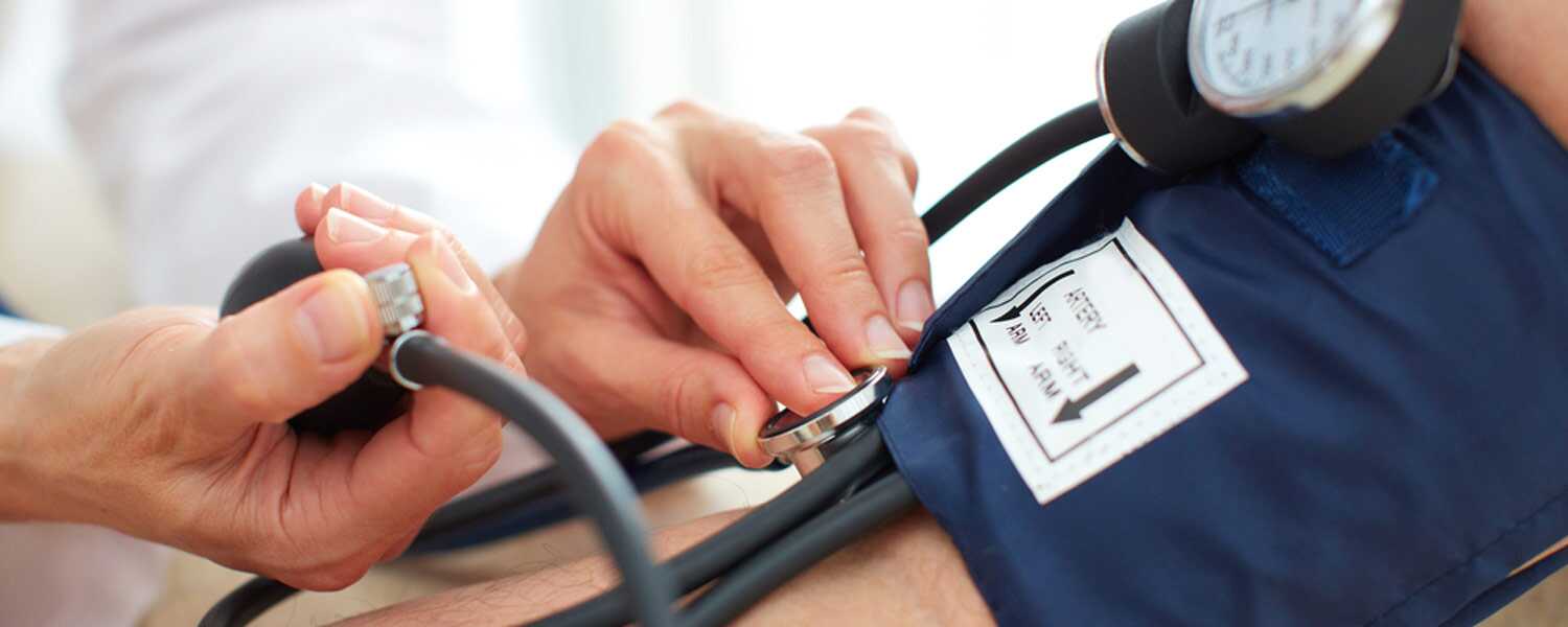 A doctor checking a patient's blood pressure.